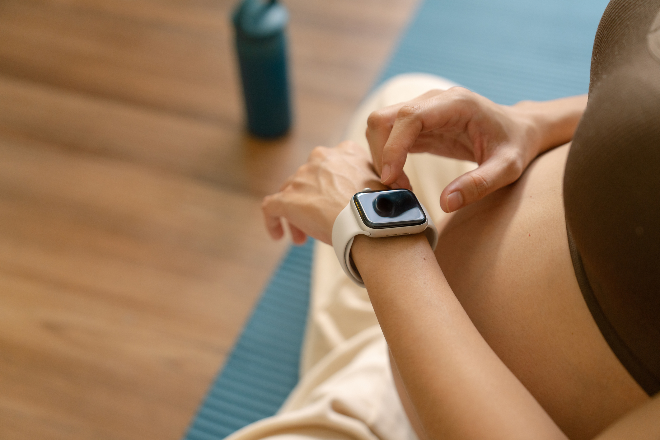 A pregnant woman taps an Apple Watch