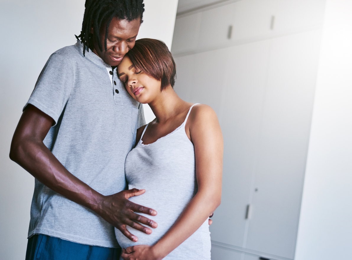 A man and pregnant woman embracing